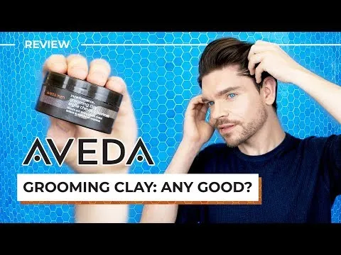 Aveda Men Pure-Formance Grooming Clay jar held in a man's hand to show the product's scale.