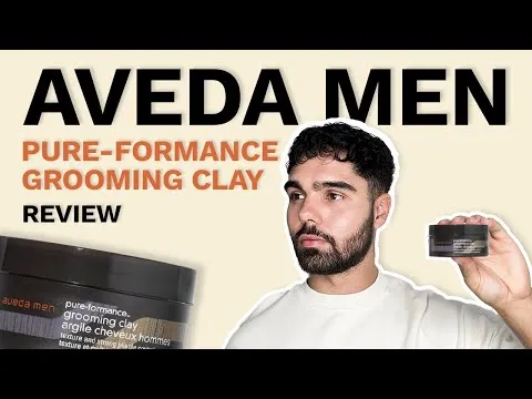 Detailed studio close-up of the Aveda Men Pure-Formance Grooming Clay product jar and label.