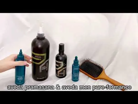 Aveda Men Pure-Formance Grooming Clay jar displayed on a white surface with other Aveda hair products.