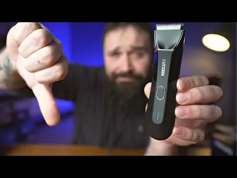 Close-up of the Manscaped Lawn Mower trimmer held vertically, displaying the front panel, power button, and LED status light